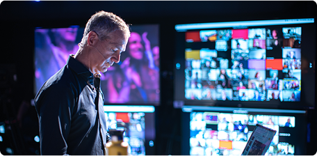 Person working at computer setup with multiple monitors